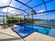 Resort-style pool and spa with screened enclosure and lake views at 7675 Summerland Cv, Bradenton, FL 34202