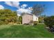 Backyard with a large storage shed and lush green grass at 8022 Snowy Egret Pl, Lakewood Ranch, FL 34202