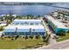 Aerial view of waterfront property, featuring colorful buildings and lush landscaping at 1007 Gulf N Dr # 106, Bradenton Beach, FL 34217