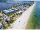 Aerial view of beach town with white sand beach and ocean at 1007 Gulf N Dr # 106, Bradenton Beach, FL 34217