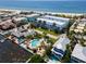 Aerial view of waterfront community with pool and tropical landscaping at 1007 Gulf N Dr # 106, Bradenton Beach, FL 34217