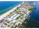 Aerial view of waterfront community with beach and tropical homes at 1007 Gulf N Dr # 106, Bradenton Beach, FL 34217