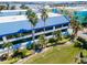 Aerial view of waterfront property with lush landscaping and tropical plants at 1007 Gulf N Dr # 106, Bradenton Beach, FL 34217