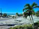 Peaceful beachfront view with palm trees and road at 1007 Gulf N Dr # 106, Bradenton Beach, FL 34217