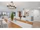 Bright dining room with a large wooden table and chandelier at 1007 Gulf N Dr # 106, Bradenton Beach, FL 34217