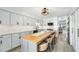 Modern kitchen with gray cabinets, a large island, and stainless steel appliances at 1007 Gulf N Dr # 106, Bradenton Beach, FL 34217