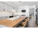Modern kitchen with gray cabinets, a large island, and stainless steel appliances at 1007 Gulf N Dr # 106, Bradenton Beach, FL 34217