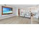 Bright living room with hardwood floors, comfortable seating, and large TV at 1007 Gulf N Dr # 106, Bradenton Beach, FL 34217