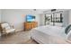 Main bedroom with dresser, king-size bed, and access to balcony at 1007 Gulf N Dr # 106, Bradenton Beach, FL 34217