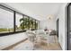 Sunroom with wicker furniture and ocean view at 1007 Gulf N Dr # 106, Bradenton Beach, FL 34217