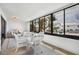 Bright sunroom offering ample seating and views of the neighborhood at 1007 Gulf N Dr # 106, Bradenton Beach, FL 34217