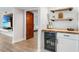 Convenient wet bar with wine cooler and shelving at 1007 Gulf N Dr # 106, Bradenton Beach, FL 34217