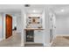Modern wet bar with wine cooler and wooden shelving at 1007 Gulf N Dr # 106, Bradenton Beach, FL 34217