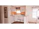 Small kitchen with white cabinets and orange walls at 10315 Cortez W Rd # 47-2, Bradenton, FL 34210