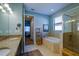 Bathroom with double vanity, soaking tub, and walk-in shower at 1035 Bradberry Dr, Nokomis, FL 34275