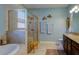 Spa-like bathroom with a large walk-in shower, soaking tub, and stylish decor at 1035 Bradberry Dr, Nokomis, FL 34275