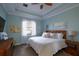 Bright bedroom with king-size bed and light blue walls at 1035 Bradberry Dr, Nokomis, FL 34275