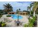 Community pool with plenty of lounge chairs and tables at 1035 Bradberry Dr, Nokomis, FL 34275
