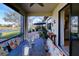 Covered patio with table and chairs overlooking the lake at 1035 Bradberry Dr, Nokomis, FL 34275