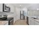 Modern kitchen with white cabinets, stainless steel appliances, and an island at 10796 Tarflower Dr # 102, Venice, FL 34293