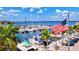 Aerial view of a marina with boats, palm trees, and an American flag at 1524 2Nd E Ave, Bradenton, FL 34208