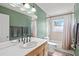 Clean bathroom with double vanity, updated fixtures, and a shower/tub combo at 1524 2Nd E Ave, Bradenton, FL 34208