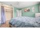 Comfortable bedroom with light walls, ceiling fan, and walk-in closet at 1524 2Nd E Ave, Bradenton, FL 34208