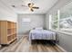 Simple bedroom with wood flooring, a twin bed, and built-in shelving at 1524 2Nd E Ave, Bradenton, FL 34208