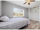 Bright bedroom with wood-look floors, ceiling fan, and window with blinds at 1524 2Nd E Ave, Bradenton, FL 34208