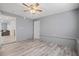 Spacious bonus room with wood-look floors, ceiling fan and exterior door at 1524 2Nd E Ave, Bradenton, FL 34208