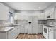 Modern kitchen boasts white cabinets, granite countertops, and a spacious layout at 1524 2Nd E Ave, Bradenton, FL 34208
