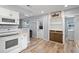 Updated kitchen with white cabinets, granite countertops, and built-in shelving at 1524 2Nd E Ave, Bradenton, FL 34208