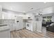 Open concept kitchen features white cabinets, granite countertops, and views into the living room at 1524 2Nd E Ave, Bradenton, FL 34208