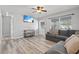 Bright living room featuring L-shaped sofa and wood-look floors at 1524 2Nd E Ave, Bradenton, FL 34208