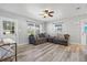 Spacious living room with L-shaped sofa and wood-look floors at 1524 2Nd E Ave, Bradenton, FL 34208