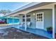 Inviting covered porch featuring white chairs and potted plants at 1524 2Nd E Ave, Bradenton, FL 34208