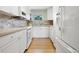 Modern galley style kitchen with white cabinetry at 2155 Wood St # B17, Sarasota, FL 34237