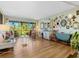 Living room with hardwood floors, eclectic decor and access to the patio at 2155 Wood St # B17, Sarasota, FL 34237