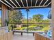 Relaxing screened patio with wooden furniture and lush garden views at 2155 Wood St # B17, Sarasota, FL 34237