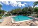 Sparkling community pool surrounded by lush foliage and patio furniture at 226 Lakewood Dr # 226, Bradenton, FL 34210