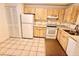 Bright kitchen with wood cabinets and white appliances at 226 Lakewood Dr # 226, Bradenton, FL 34210