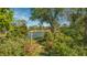 Charming arbor accents the garden path by the lake at 269 Pine Ranch Trl, Osprey, FL 34229