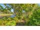 Lush landscaping surrounds a serene canal at 269 Pine Ranch Trl, Osprey, FL 34229