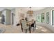 Bright dining area with a rustic table and modern chandelier at 269 Pine Ranch Trl, Osprey, FL 34229