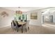 Elegant dining room with large windows and view to entryway at 269 Pine Ranch Trl, Osprey, FL 34229
