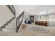 Open entryway with modern staircase and view into kitchen and living area at 269 Pine Ranch Trl, Osprey, FL 34229