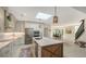 Modern kitchen with large island, stainless steel appliances, and skylights at 269 Pine Ranch Trl, Osprey, FL 34229