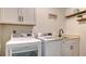 Clean laundry room, featuring a washer, dryer, and utility sink at 269 Pine Ranch Trl, Osprey, FL 34229