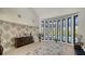 Living room with large windows and tropical-themed wallpaper at 269 Pine Ranch Trl, Osprey, FL 34229