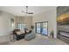 Living room with comfortable seating, fireplace, and access to backyard at 269 Pine Ranch Trl, Osprey, FL 34229